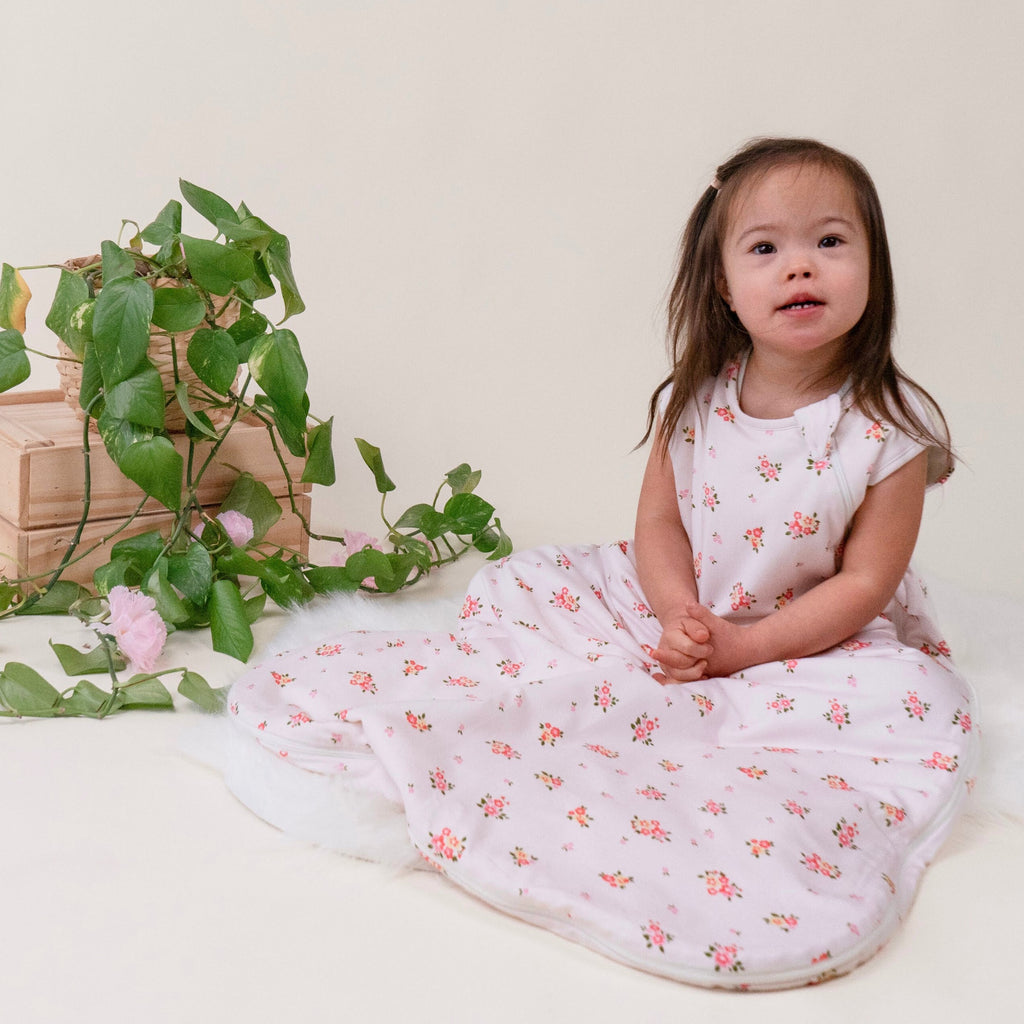 toddler girl wearing sleep sack in blushing blossom print