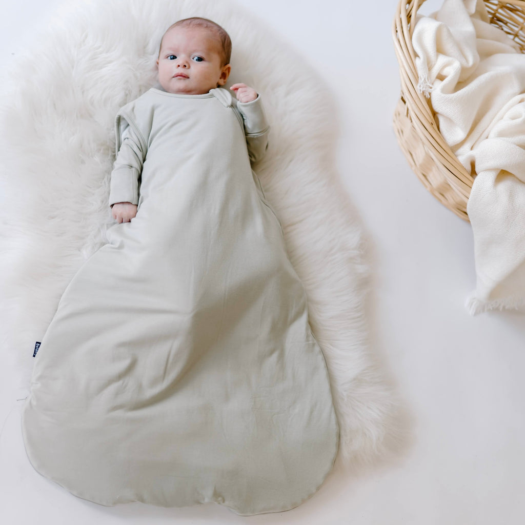 baby wearing sleep bag in Sage solid color