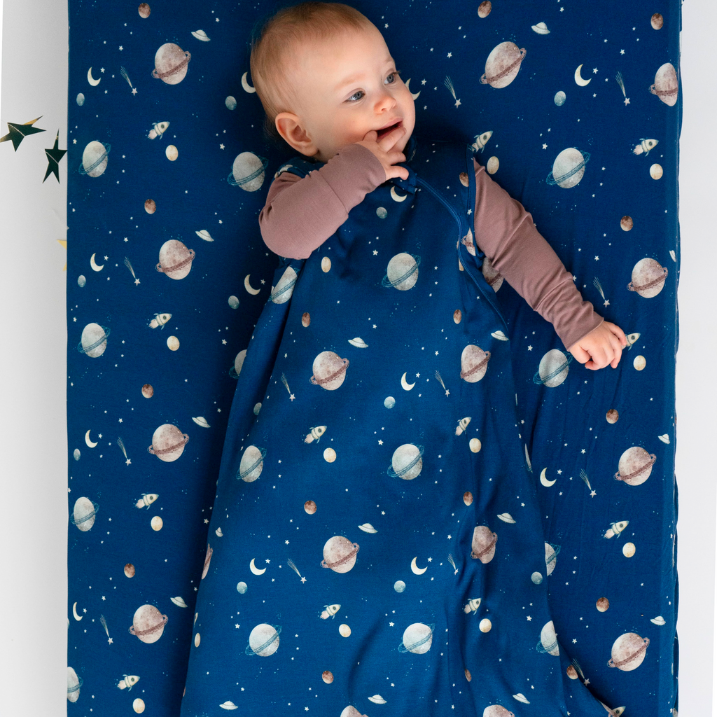 baby wearing sleep bag in space print