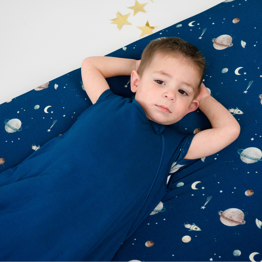 baby wearing sleep bag in deep blue solid color