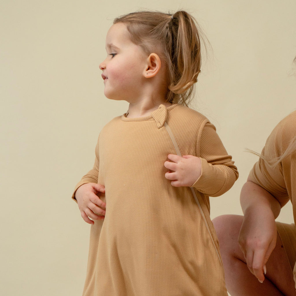 baby wearing ribbed bamboo sleep sack in amber color