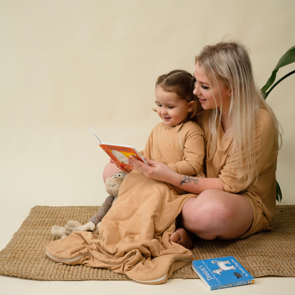 mother and baby girl, mother is wearing women's summer pj set in amber color and child is wearing ribbed bamboo sleepsack in the same color