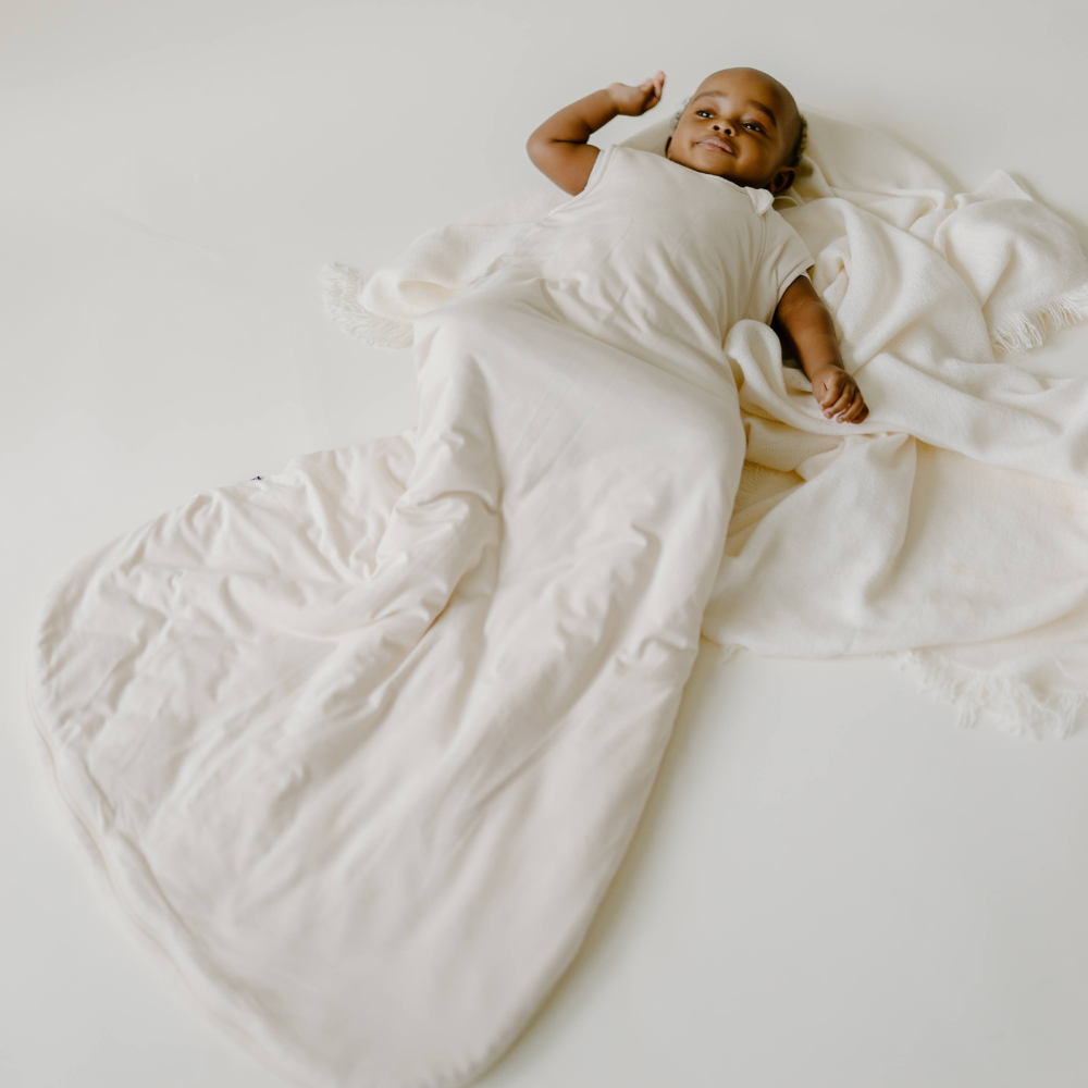 baby wearing sleep bag in seaside sand solid color