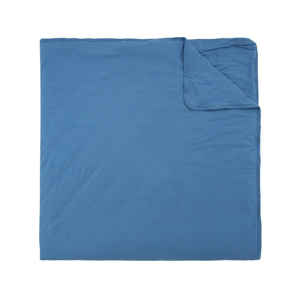 quilted child blanket in marine blue solid color